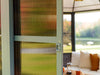 Screen door with a view of a living room and outdoor area.
