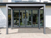Gazebo Penguin Vikos Pergola on patio in front of glass door