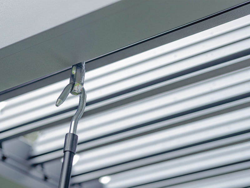 Roller shutter with a tool for adjusting the roller