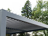 Metal pergola structure with trees in the background
