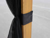 Black curtain tieback attached to a wooden pole against a neutral background
