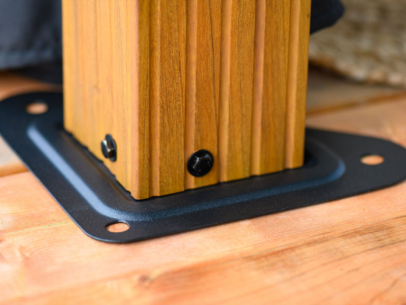 Wooden block with metal bracket on a wooden surface