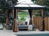 Outdoor gazebo with curtains, cushions, and a daybed by a body of water.